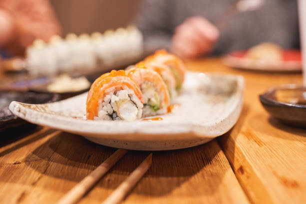 istock Fresh sushi rolls on a ceramic plate with chopsticks. 2193217446