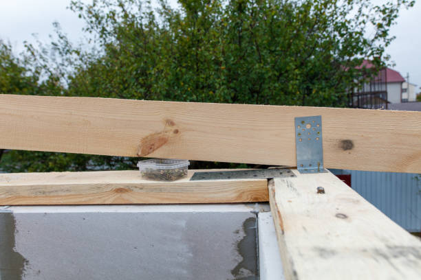 istock A wooden beam is being used to support a roof 2193217864