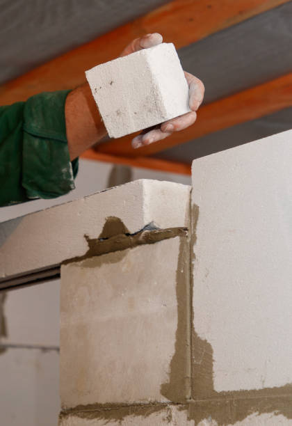 istock A man is holding a white block of cement 2193217913