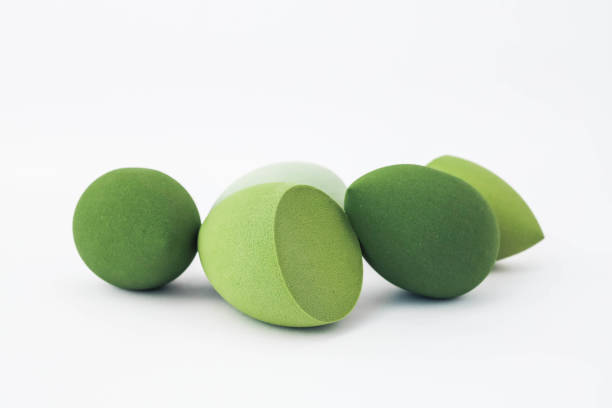 istock Green makeup sponges on a white background. A minimalist composition showcasing beauty tools for foundation blending, perfect for skincare and cosmetics themes 2193218152