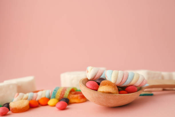 Assortment of sweets on a soft pink background, banner, advertising.