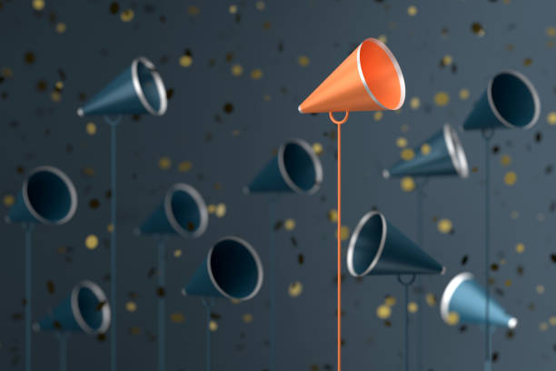 istock Megaphones On Confetti And Standing Out From The Crowd 2193219575