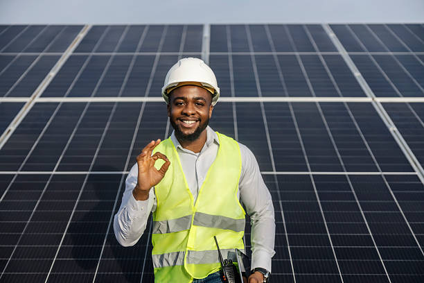 istock Portrait of young multicultural engineer standing at solar farm and gesturing okay while smiling at camera. 2193219925
