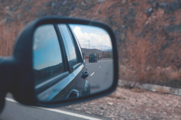 istock rear view mirror of car on the highway 2193220421