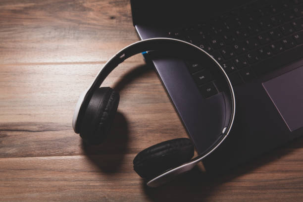 istock headphones with laptop on wooden table 2193220432