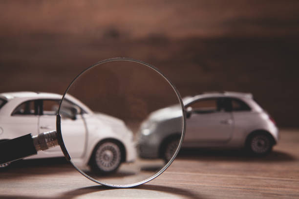 istock car model and car on wooden table. 2193220544