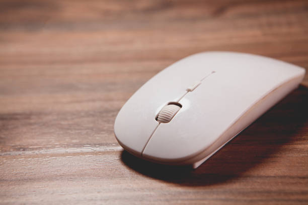 istock white mouse on a wooden desk. 2193220545