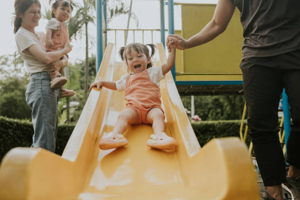 istock Cute Asian young girl is laughing while playing in the playground. 2193222149