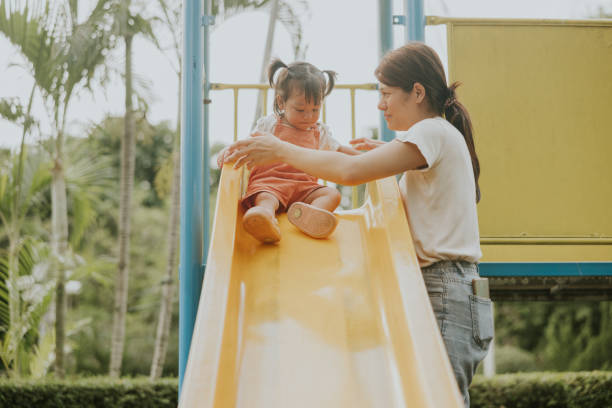 istock Talking  before play,  Southeast  Asian mother and kids while playing  the slider. 2193222206