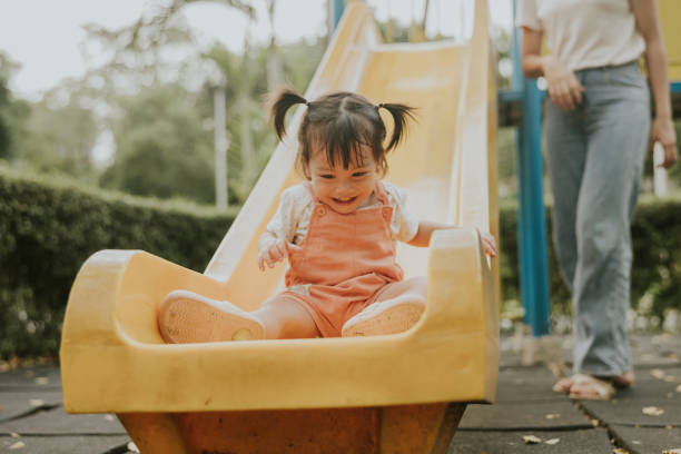 istock Laughing girl while having fun with sliding tool at the playground 2193222247