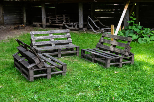 istock Rustic wooden seating arranged in a grassy area within a traditional outdoor setting 2193223006