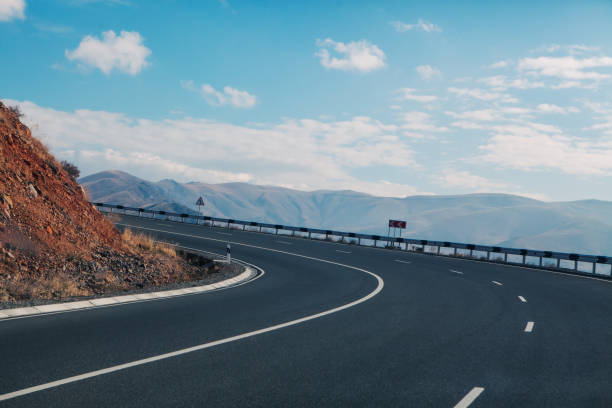 istock beautiful mountain road at sunset 2193223709