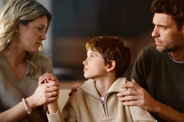 istock Worried parents consoling their sad son at home. 2193224475