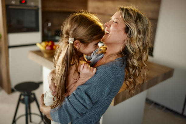 istock Cheerful mother having fun with her daughter at home. 2193225052