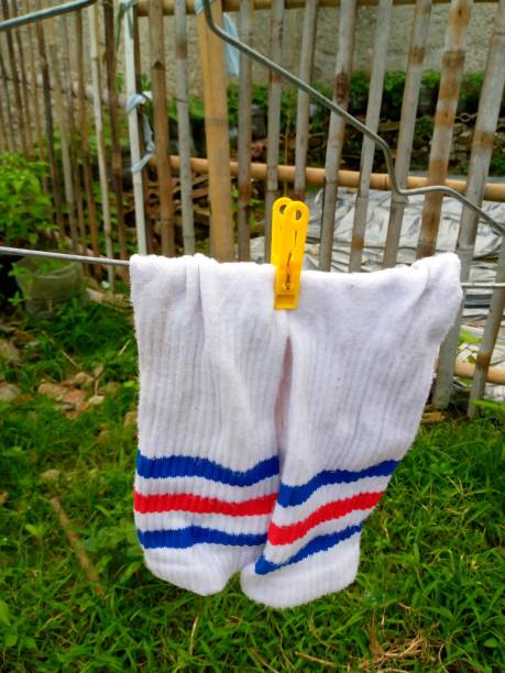 background of socks on a hanger with clothespins being dried