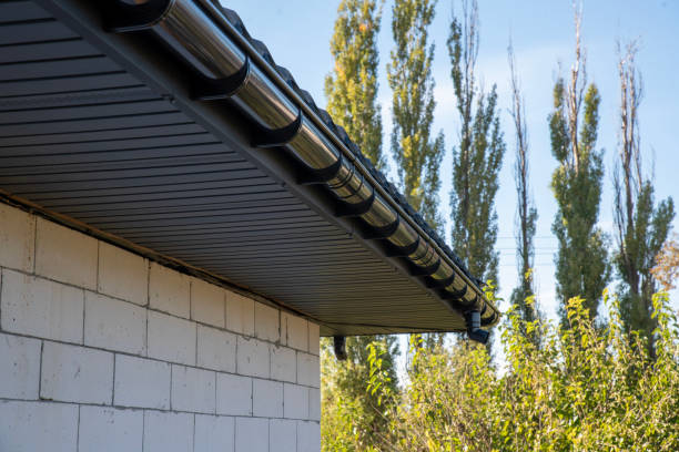 istock A gray pipe and rain gutter is attached to the roof 2193225637