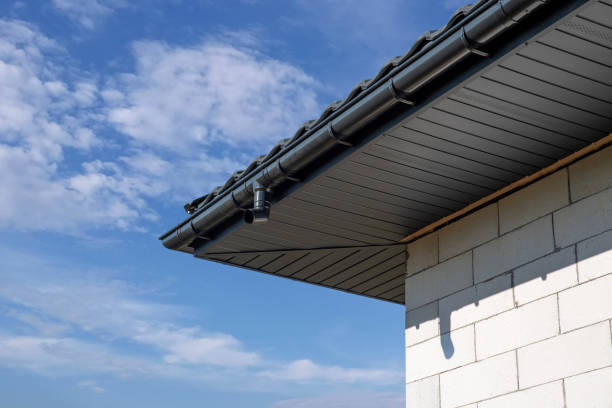 Modern home roof design featuring security camera under clear blue sky in bright daylight setting