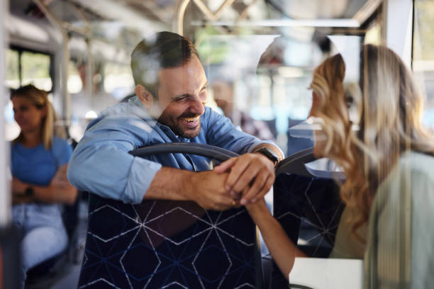 istock Happy man talking to female passenger in a bus. 2193226149