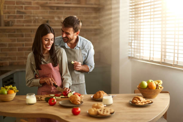 istock Happy couple enjoying while preparing meal in dining room. 2193227031