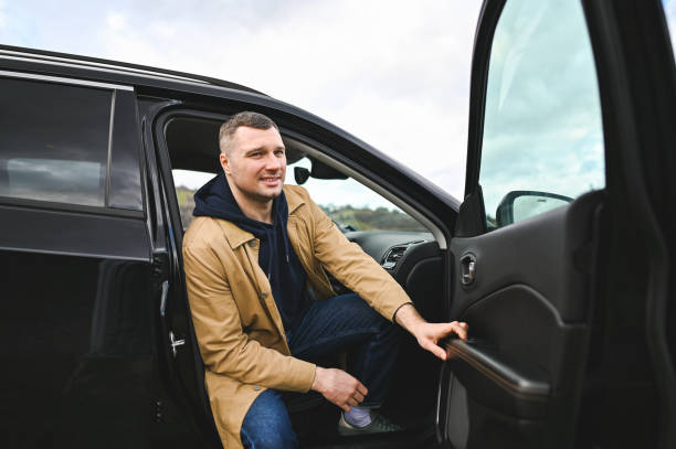 Portrait of handsome man sitting in car.