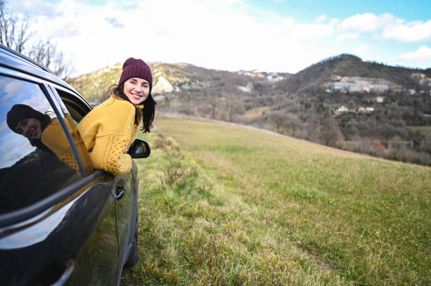 Cheerful tourist woman in car.