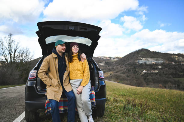 istock Couple in field trip with car. 2193227369