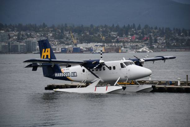 Vancouver, Canada – September 28, 2024: Seaplane docked on water near a deck in Vancouver, British Columbia