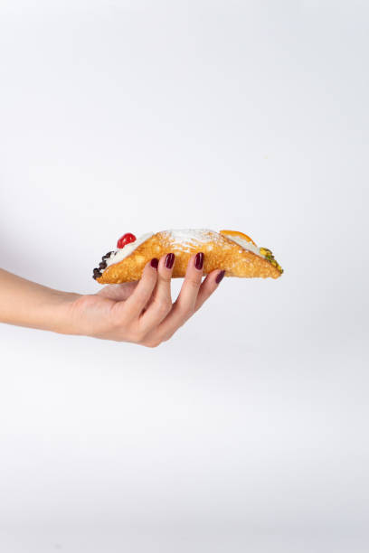 istock Hand holding a Sicilian cannoli 2193237211