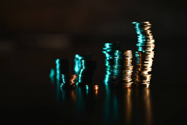 growing stacks of coins on back background.