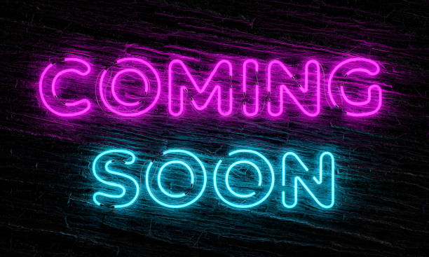 istock Coming soon neon sign on dark wooden background 2193240590