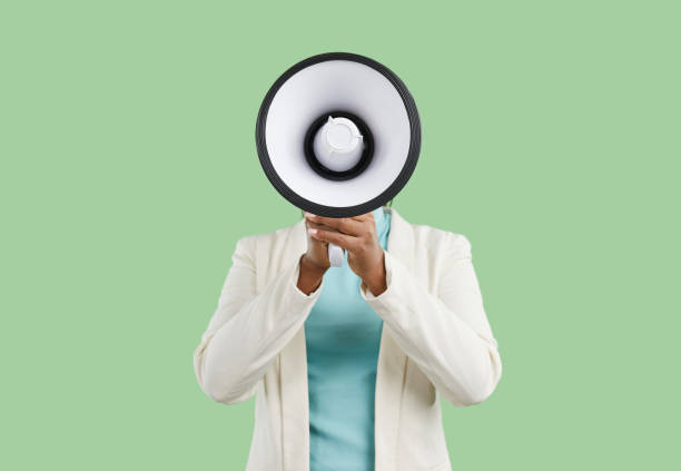 istock Black woman shouting through megaphone and making announcement with her loud voice 2193242528