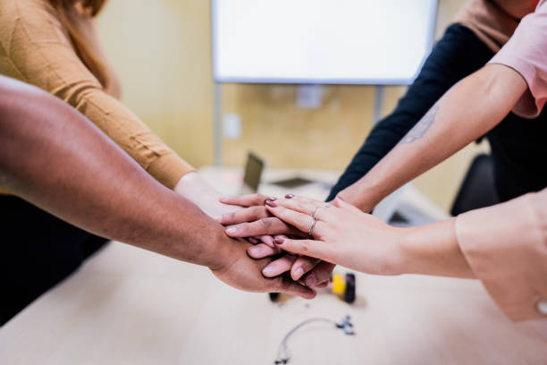 istock Close-up of a coworkers with hands clasped on the office 2193242556