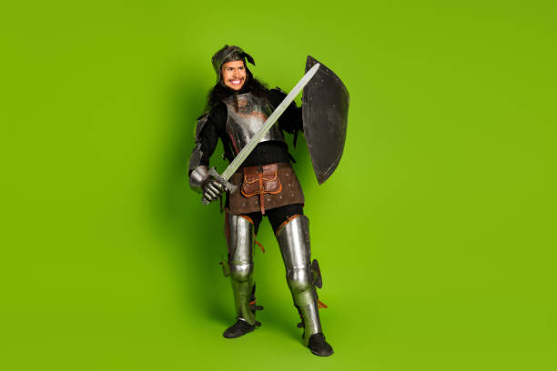 istock Medieval knight in armor holding sword and shield on green backdrop showcasing history and nobility 2193243152