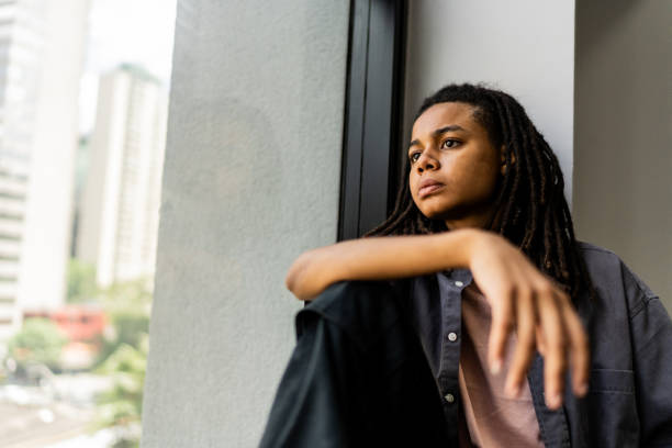 istock Non-binary gender business person contemplating on the office 2193243420