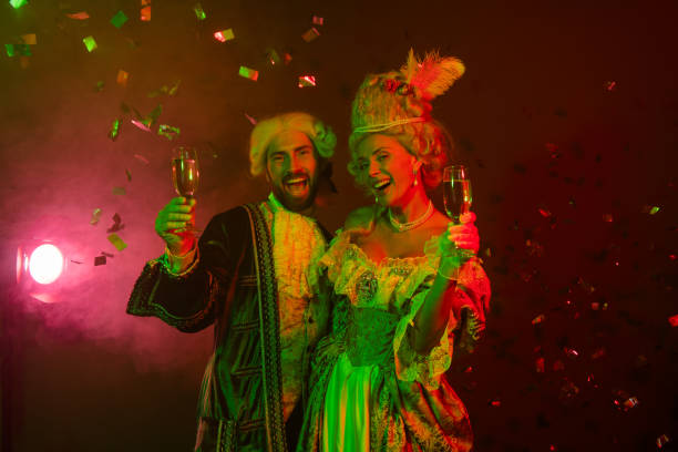 istock Two costumed individuals celebrating at a themed party with drinks and confetti 2193243812