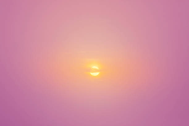 A radiant sun surrounded by bold pink and orange hues, captured in a serene sunset moment