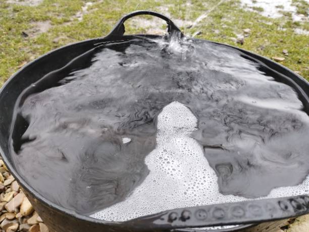 istock Macro shot of a large rubber basket filled with water and foam into which water flows from a drainpipe. 2193247076