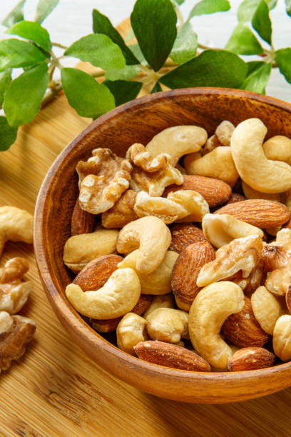 istock Assortment of nuts in wooden bowl 2193247531
