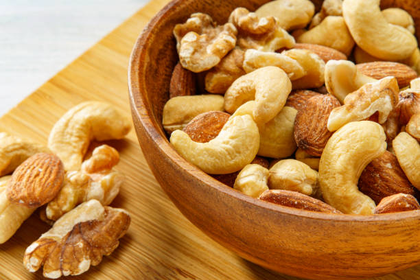 istock Assortment of nuts in wooden bowl 2193247553