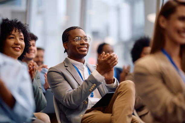 istock Happy black businessman applauding on education event at conference hall. 2193247556