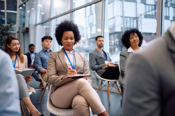 istock Black businesswoman taking notes during a conference in board room. 2193247679
