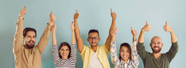 istock People with approving expression looking at camera showing success and like gesture on background. 2193247701