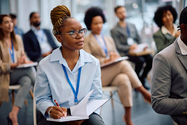 istock Young black businesswoman taking notes while attending an education event in board room. 2193247713