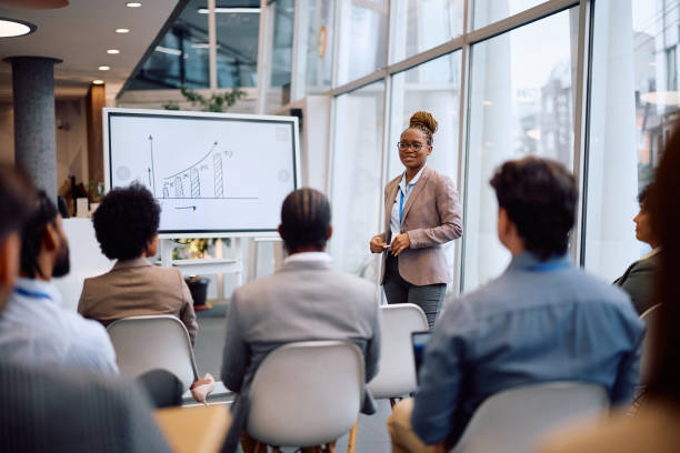 istock Black female speaker talking on business seminar in conference room. 2193247935