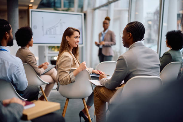 istock Happy colleagues talking during a business conference in board room. 2193247967