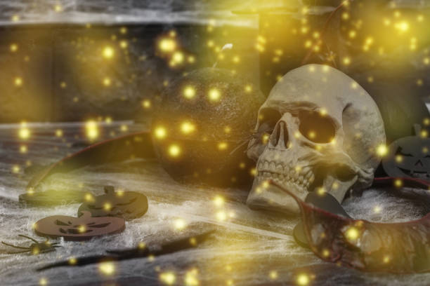 Creepy Halloween composition. Creative background, traditional symbols. Decorative skull, candles, spider web, pumpkins and bats. Dark atmosphere mood