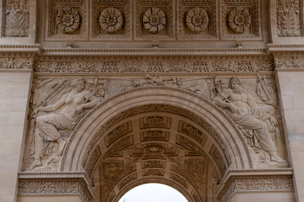 istock Intricate sculptures on the arch of a historic monument featuring classical figures and detailed carvings in a European city 2193252129