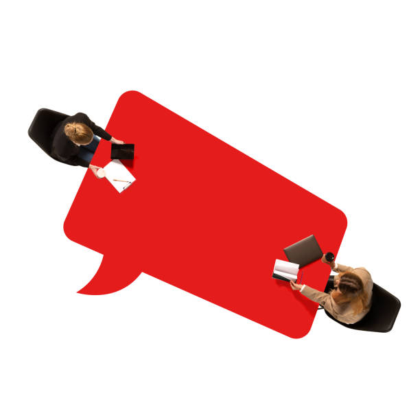 Contemporary art design. Two people at table surrounded by red speech bubble, symbolizing dynamic conversation and interaction, possibly debate or discussion. Concept of communication, business. Ad