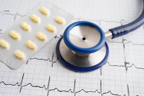 istock Stethoscope on electrocardiogram ECG with capsule drug, heart wave, heart attack, cardiogram report. 2193256466