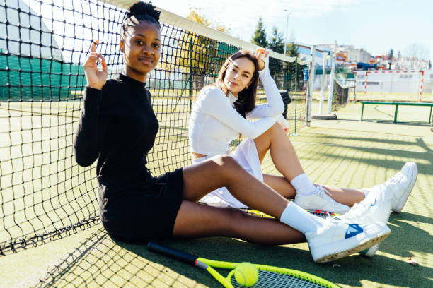 istock Two Women Sitting By Tennis Net 2193257682